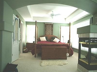 The Master Bedroom, which includes a three sided fireplace and a sitting room.