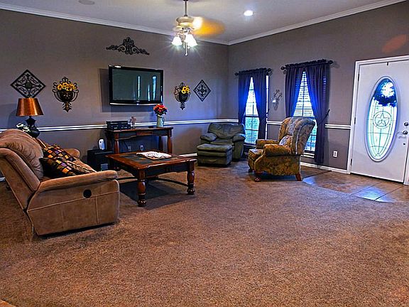 The living room offers plenty of room for entertaining guests yet is a comfortable setting for a quiet evening with just family.