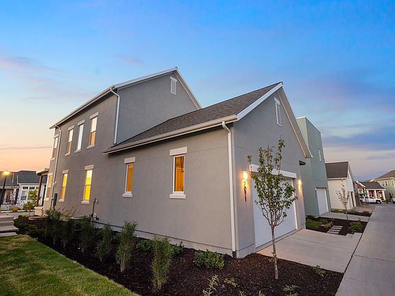 A modern two-story gray house from the Contempo Collection with white trim, a two-car garage, and il