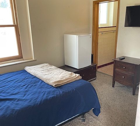 Bedroom 1 is a lock-off unit with full access to the upstairs apartment. It is located on the first floor, just inside the Door to the apartment. Has its own partial bathroom.