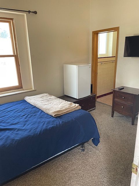 Bedroom 1 is a lock-off unit with full access to the upstairs apartment. It is located on the first floor, just inside the Door to the apartment. Has its own partial bathroom.