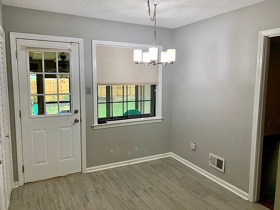 Modern light fixture, pantry and handy laundry nearby.