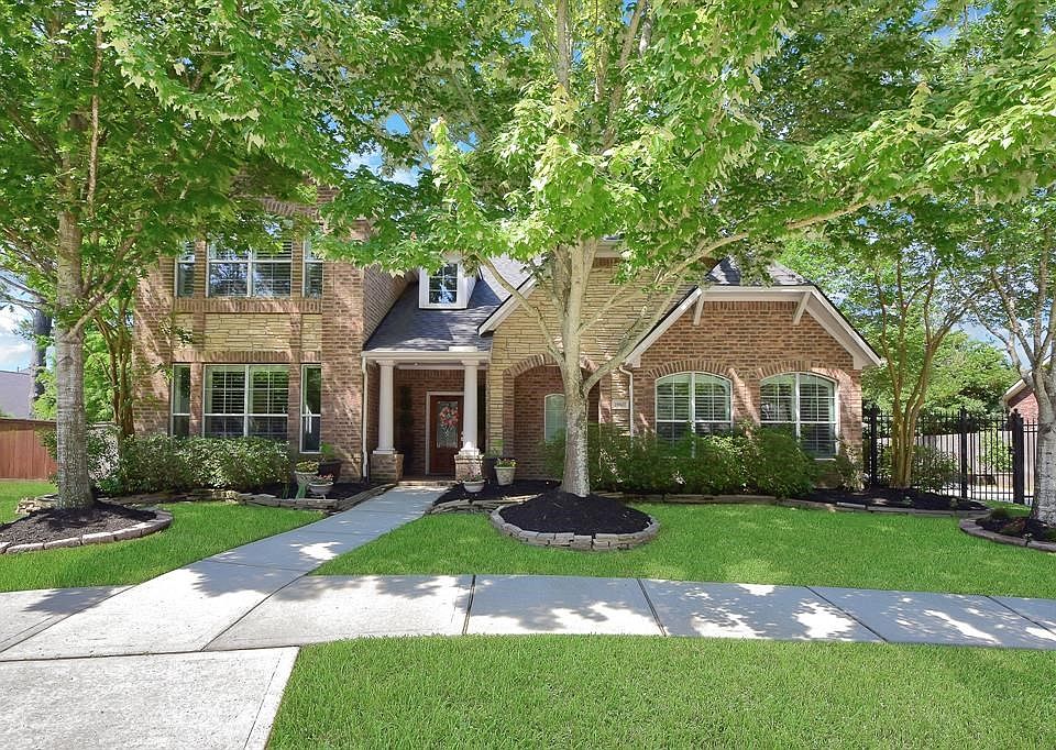 Gated driveway that leads to a full 3 car garage