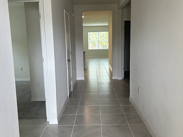 Tiled foyer/entryway with tons of light from rear conservation area.