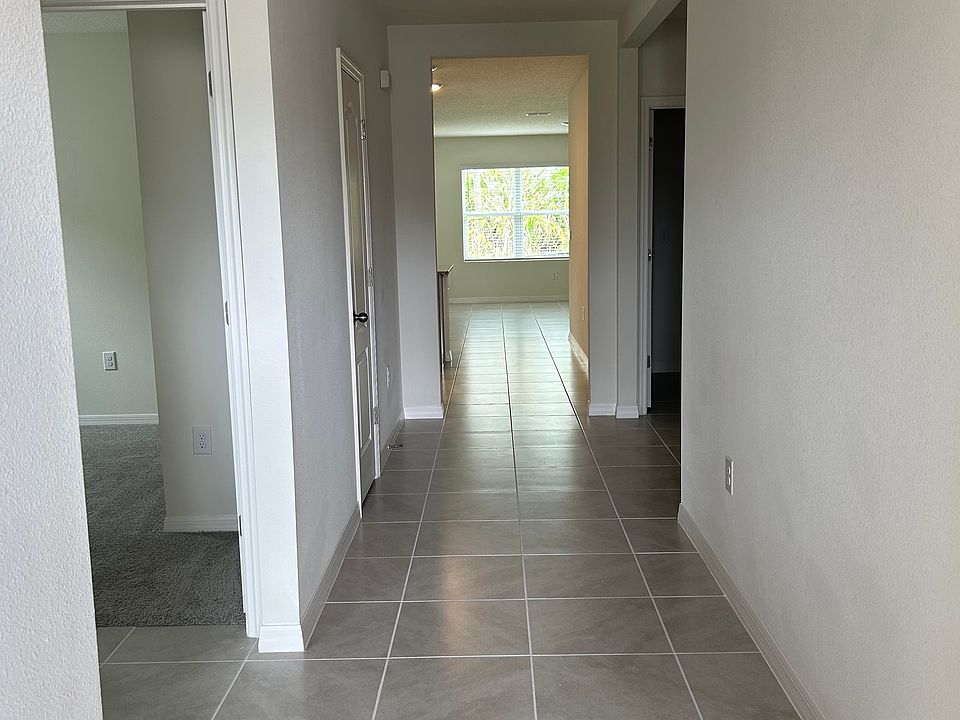 Tiled foyer/entryway with tons of light from rear conservation area.