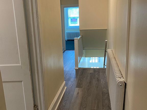 Grayish brown hardwoods in the hallway and the living room
