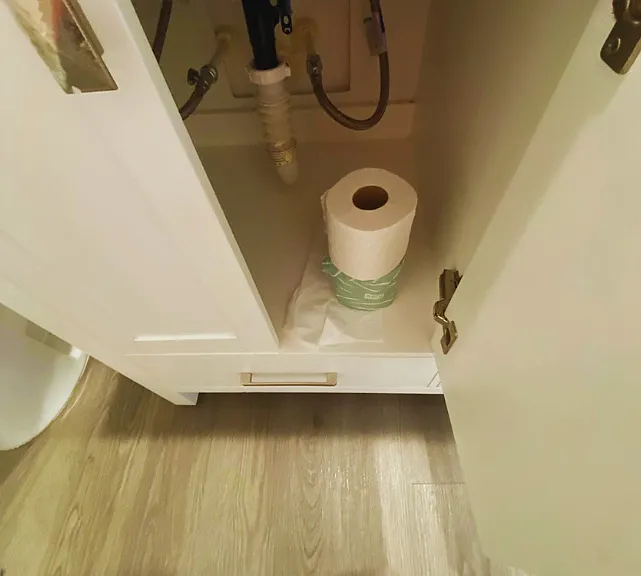 Toilet paper is available inside the cabinet.