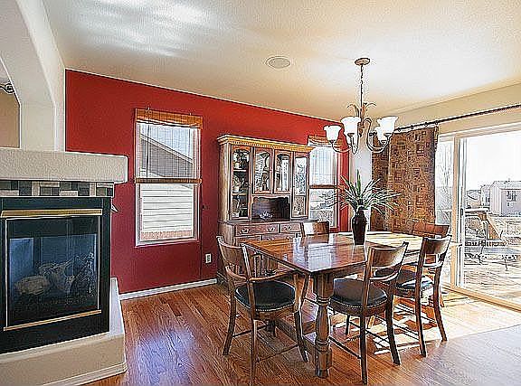 Formal dining area features designer colors with walk-out to deck.