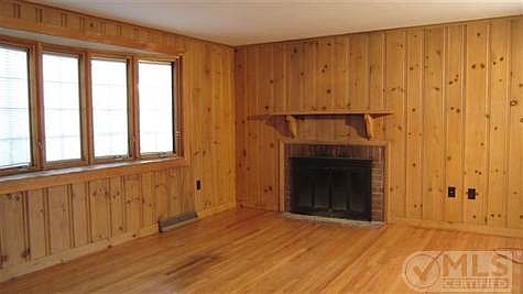 Livingroom with fireplace and beautiful hardwood floors.