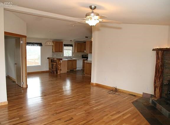 Upon entering the front door of the home you are greeted by beautiful solid hard wood floors and a custom wood burning stove to your right.