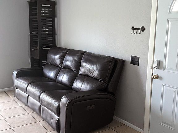Large, comfortable recliner sofa, tiled floors throughout the condo