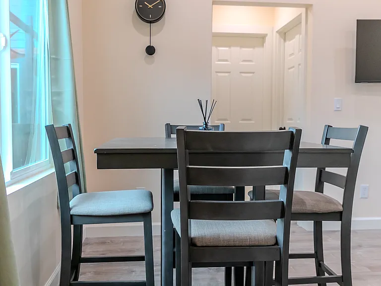 Spacious open-concept kitchen, living, and dining area situated between two bedrooms, offering both flow and privacy