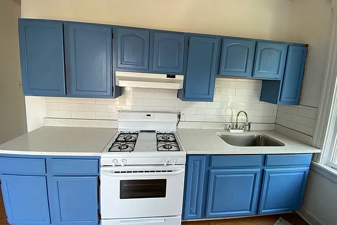 Kitchen with quartz countertops and stainless sink.