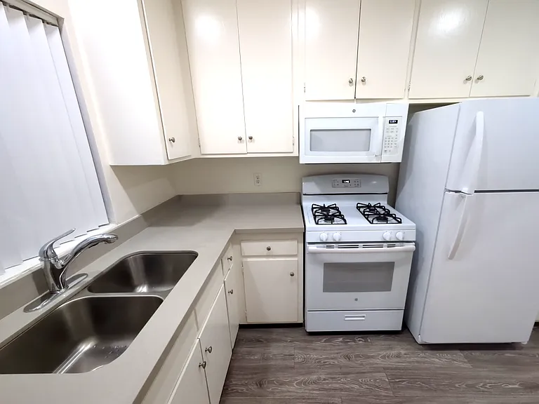 kitchen with stove, microwave, and refrigerator