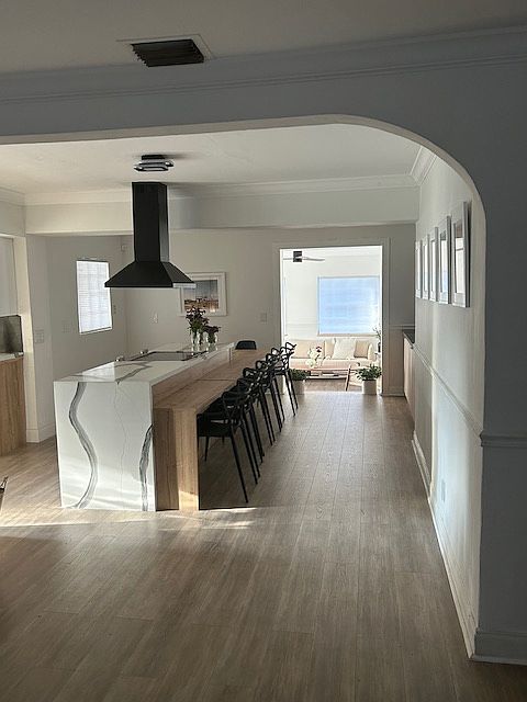 Open kitchen space with 10 seating and a 75 inch smart tv