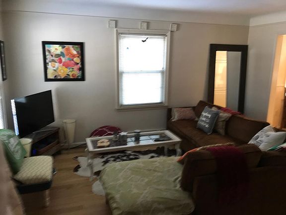 Living room with 2 large windows and hardwood floors