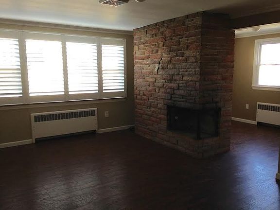 Large living room with exposed brick : Brand new high end shutters; fireplace; 2 separate eating are