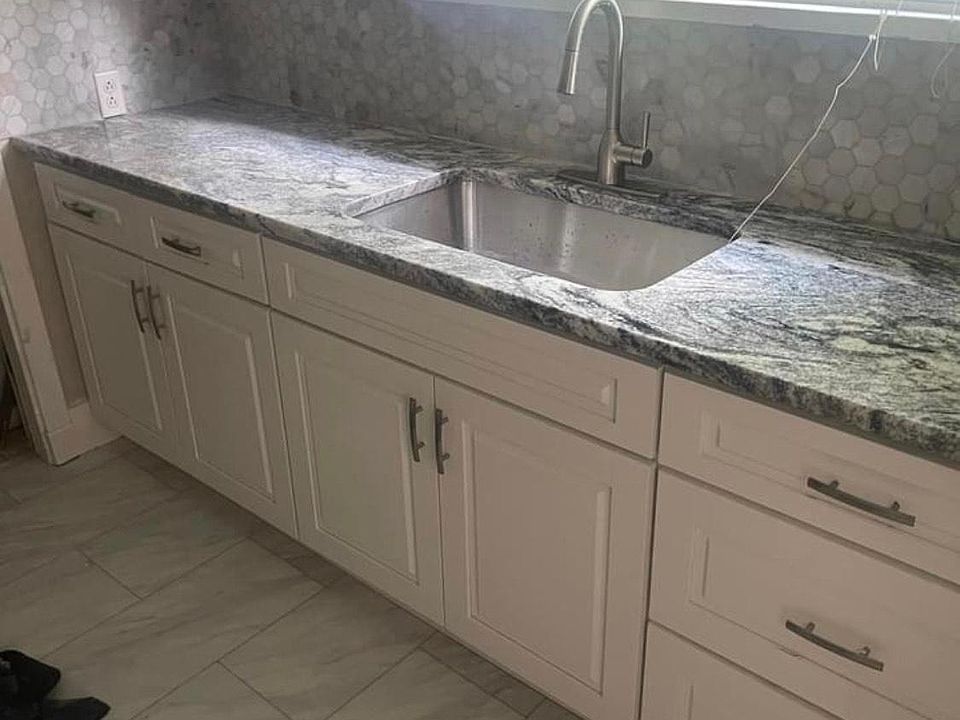 Newly remodeled kitchen with gas stove and stainless steel refrigerator