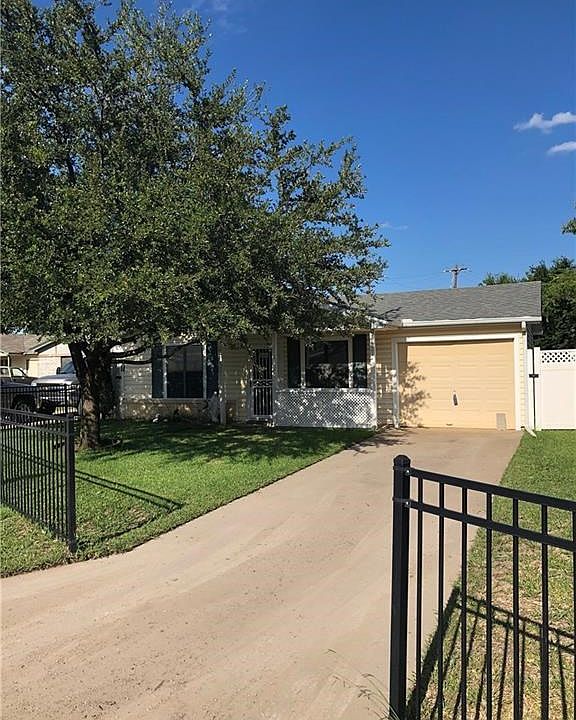 Cute home with iron front fence and established Oak tree.