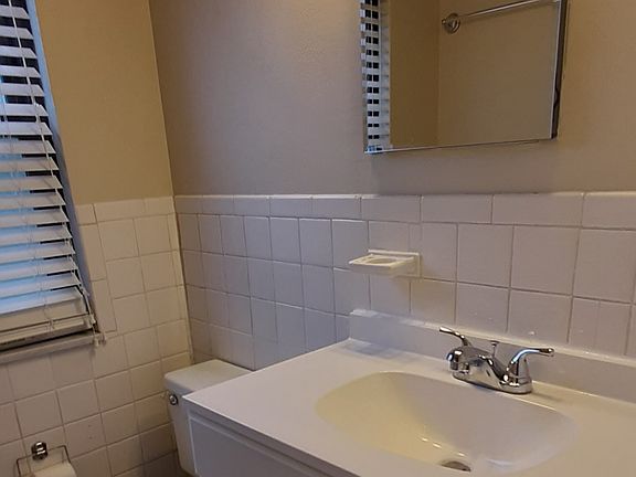 Bathroom upstairs, tile floor, laundry shoot.