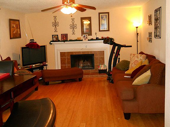 Den with stone fireplace