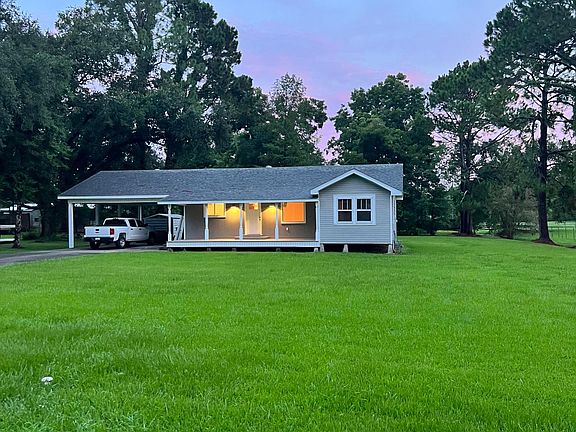 Covered parking for 4 vehicles and large front yard.
