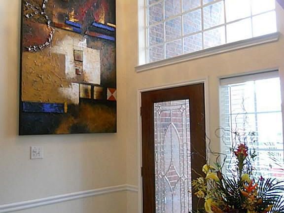  Home's foyer includes a custom chandler.