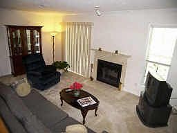 Freshly painted/recarpeted LR with fireplace and glass doors to deck.