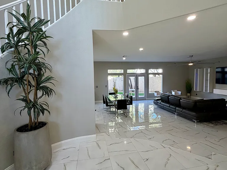 Light-filled foyer overlook offering a clear view into the home's open living and dining areas.