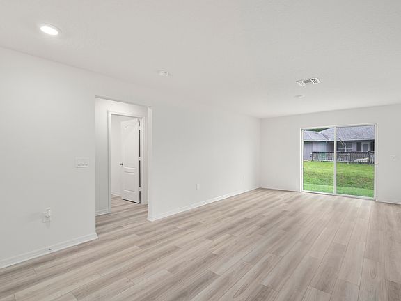 The family room is spacious and has a sliding glass door leading to the backyard