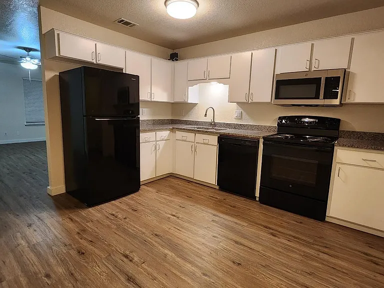 Large kitchen with granite countertops, lots of cabinets with modern doors and pulls, air switch for new disposal and all new appliances.