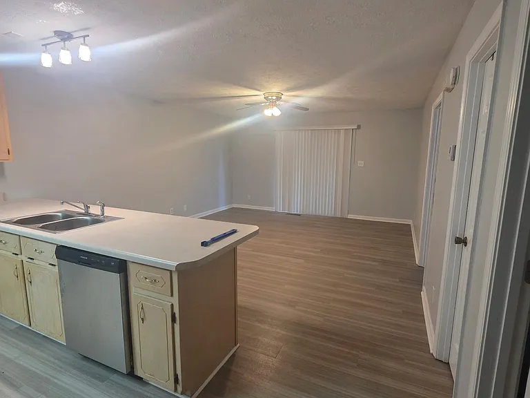 Kitchen bar overlooking living room and lake view when drapes open to deck