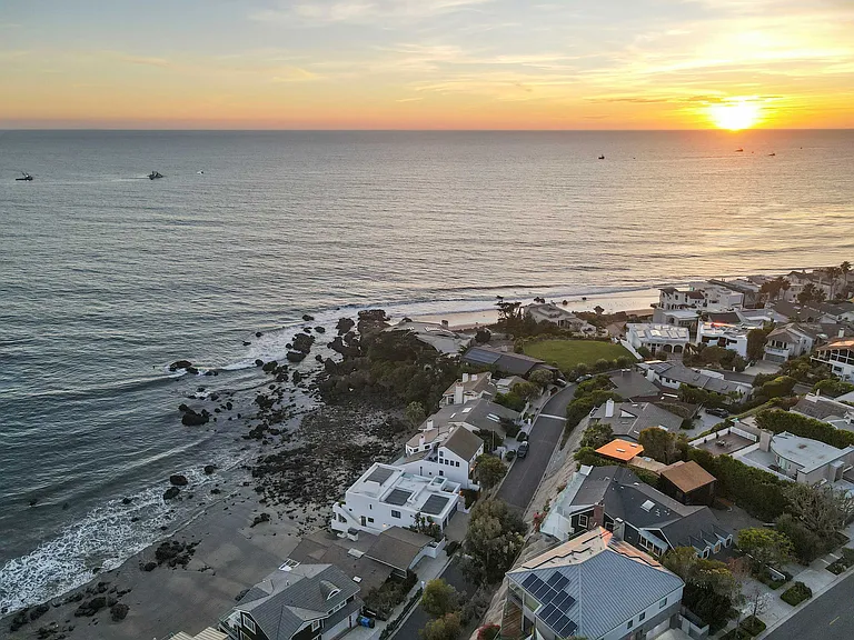 Witness Malibu's beauty under a golden sky.