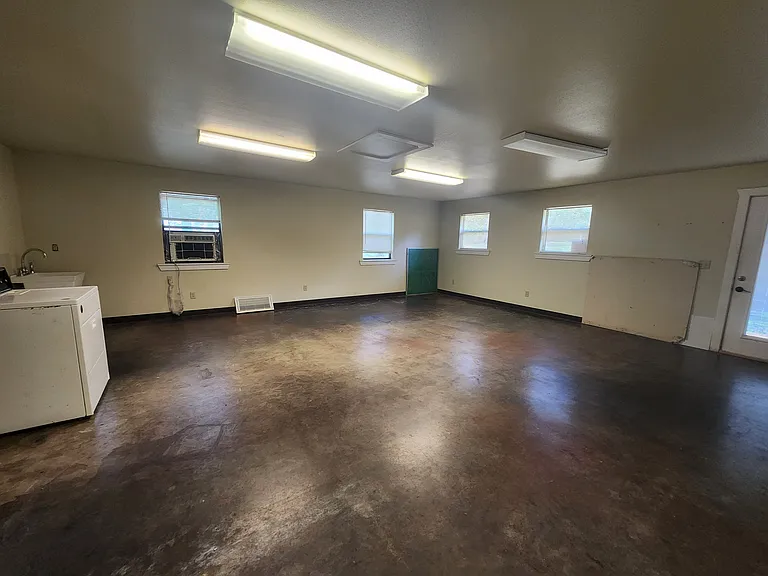740' space for 3rd bedroom, bunkroom, cabin laundry, workshop, or storage area. Door header ready for conversion for an overhead garage door.