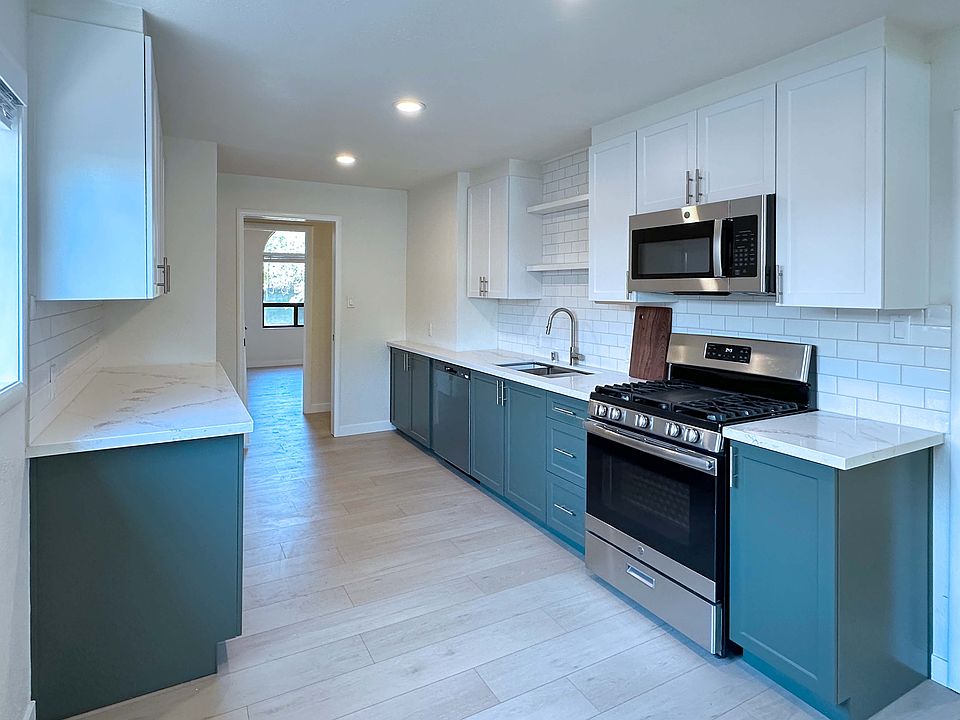 Gorgeous new kitchen equipped with stainless steel appliances and durable quartz countertops.