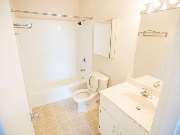 Spacious Bathroom with shower head and towel rack upgrades