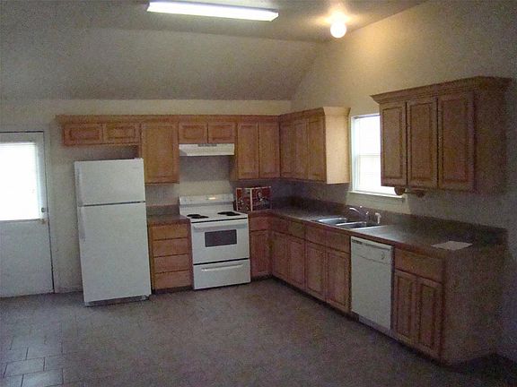 OPEN KITCHEN TO LIVING ROOM WITH TILE THROUGH OUT.