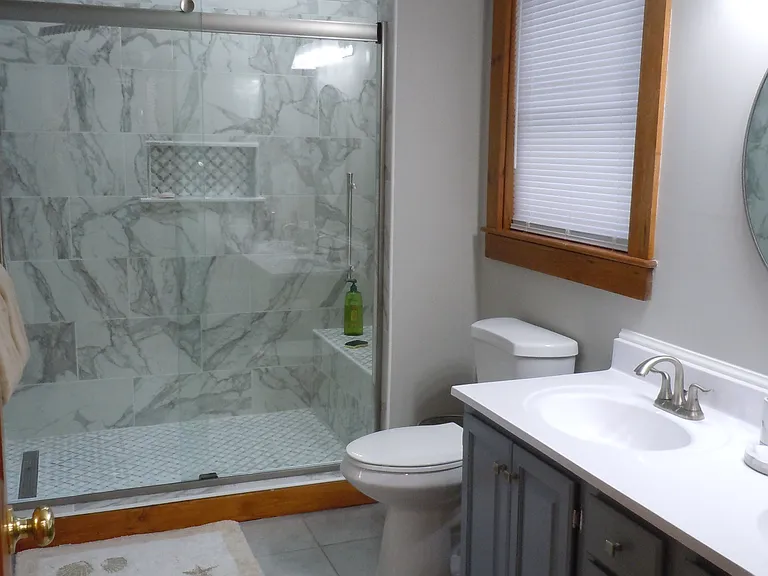 Renovated first floor bathroom with granite shower off first floor bedroom and hallway