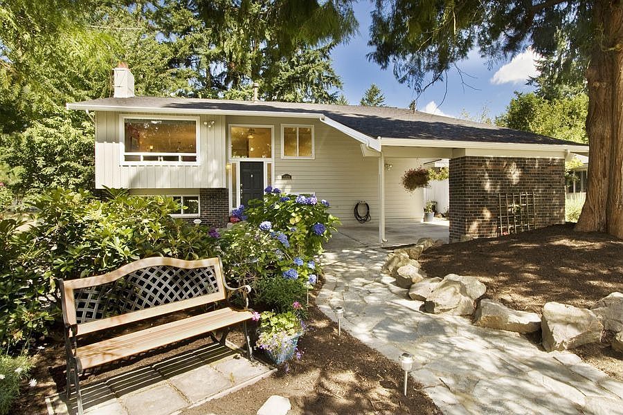 The curving flagstone path invites you into this stunning home.