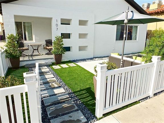 The exterior boasts a luxurious maintenance free lawn, custom fence with built in solar caps, beautiful landscaping with a large patio area for entertaining or playing with the kids.  The midcentury style of the house makes it one of a kind in this area o