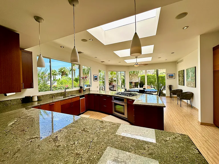 Kitchen open to dining and backyard