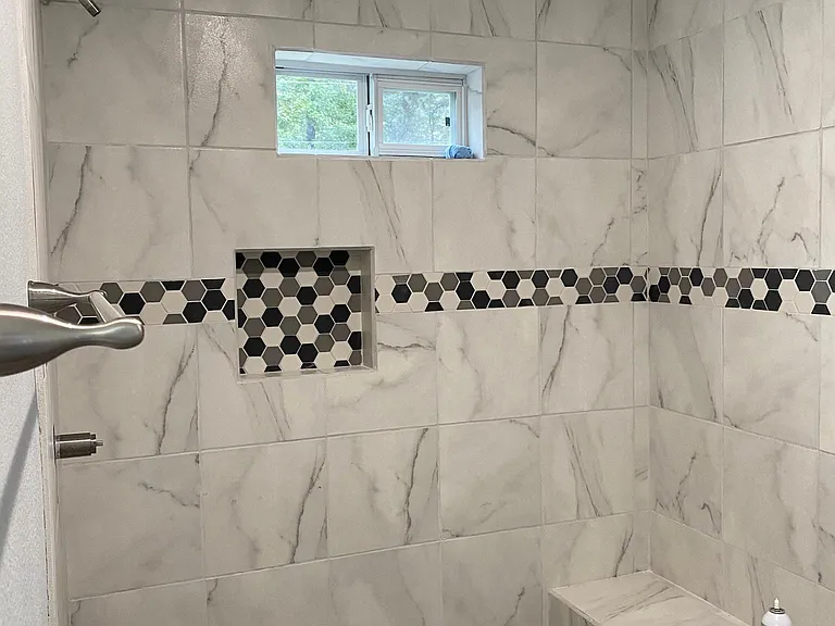 Large shower with niche and bench downstairs