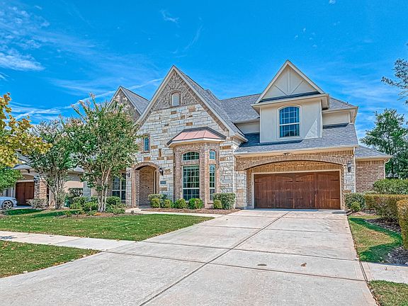 3 car garage with a long and spacious driveway. Note, neighborhood has side walks!