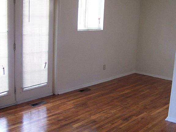 Living room with French doors to balcony and dining room wit