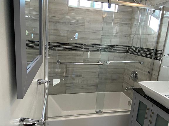 All new bathroom with Italian tile, new glass enclosure, tub and shower.