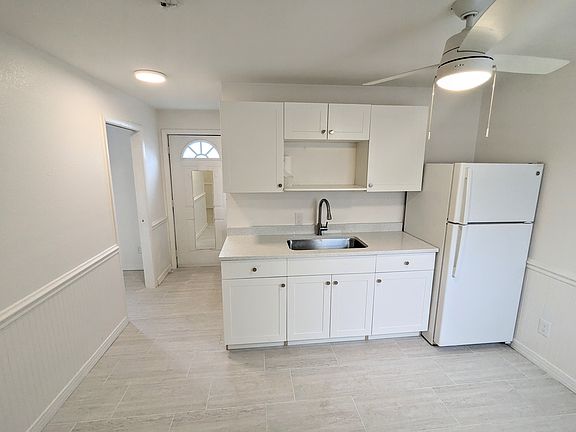 Facing kitchen, front door, bedroom door