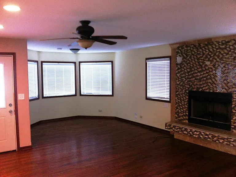 First floor open concept, tv, fireplace, living room area and dining area when empty.