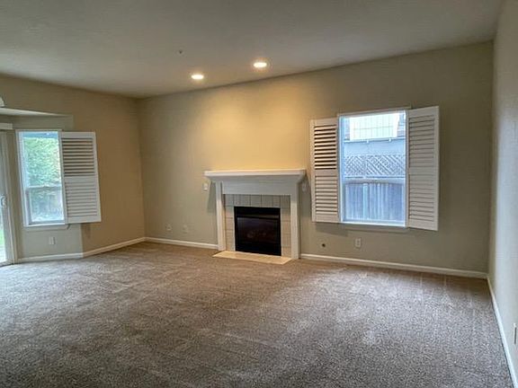 Den/family room off of kitchen with fireplace and sliding glass door