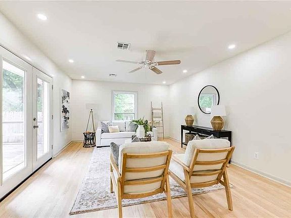 Beautiful natural hardwood floors, recessed lighting, ceiling fan, new energy efficient windows, and window treatments (not shown).