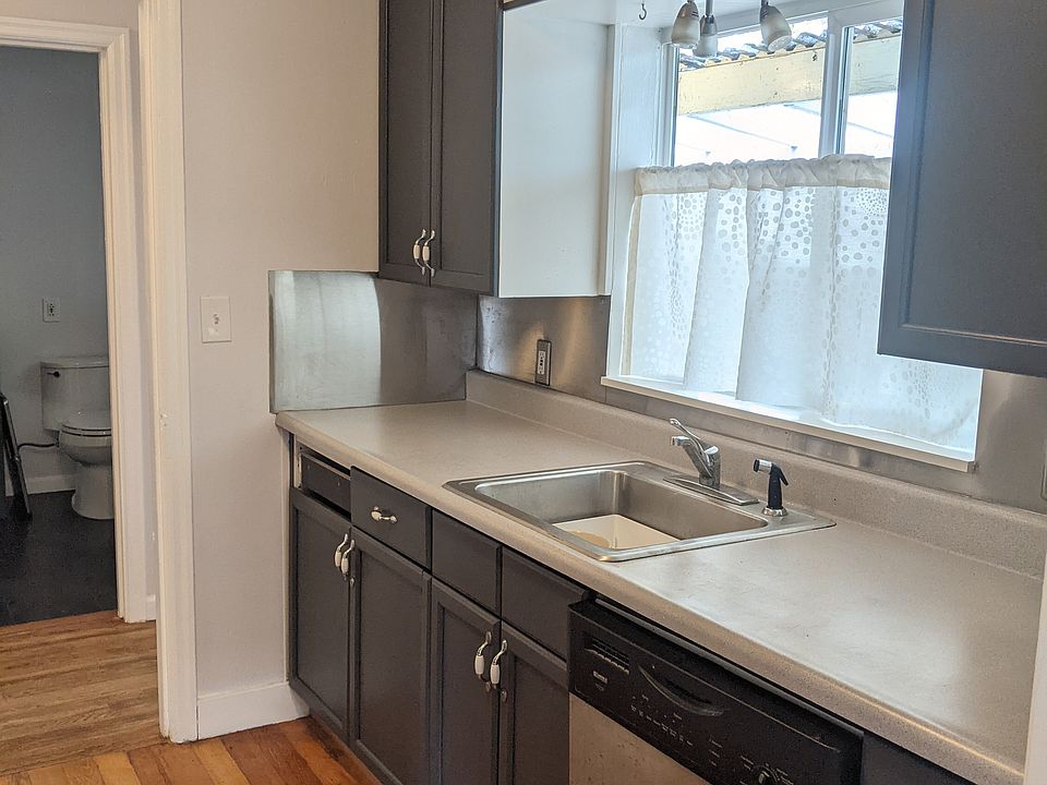 Newly painted kitchen with dishwasher, microwave, oven and fridge